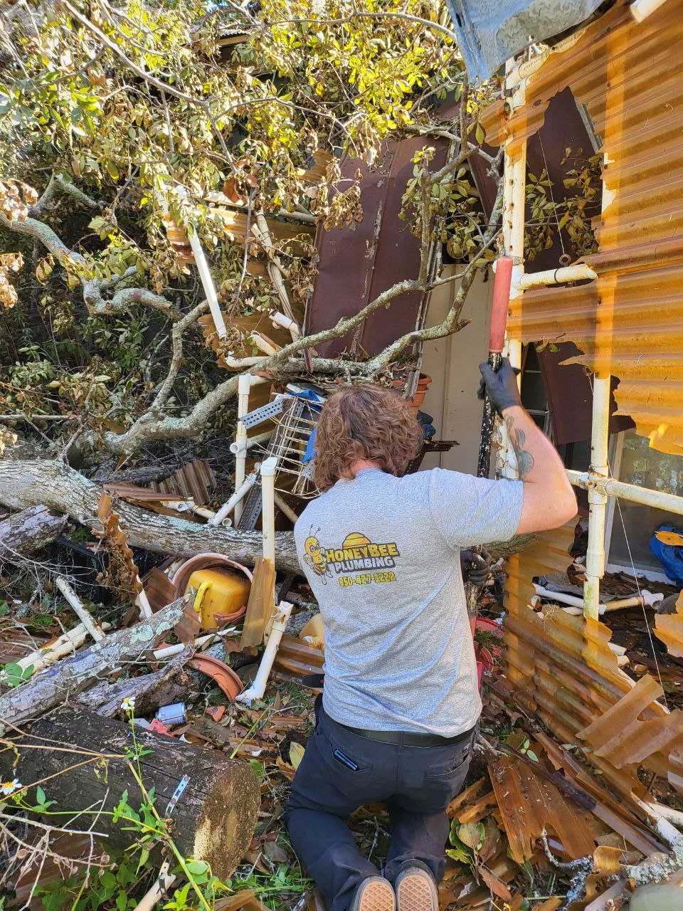 Honey Bee Plumbing working through storm debris to reach Donna’s water line