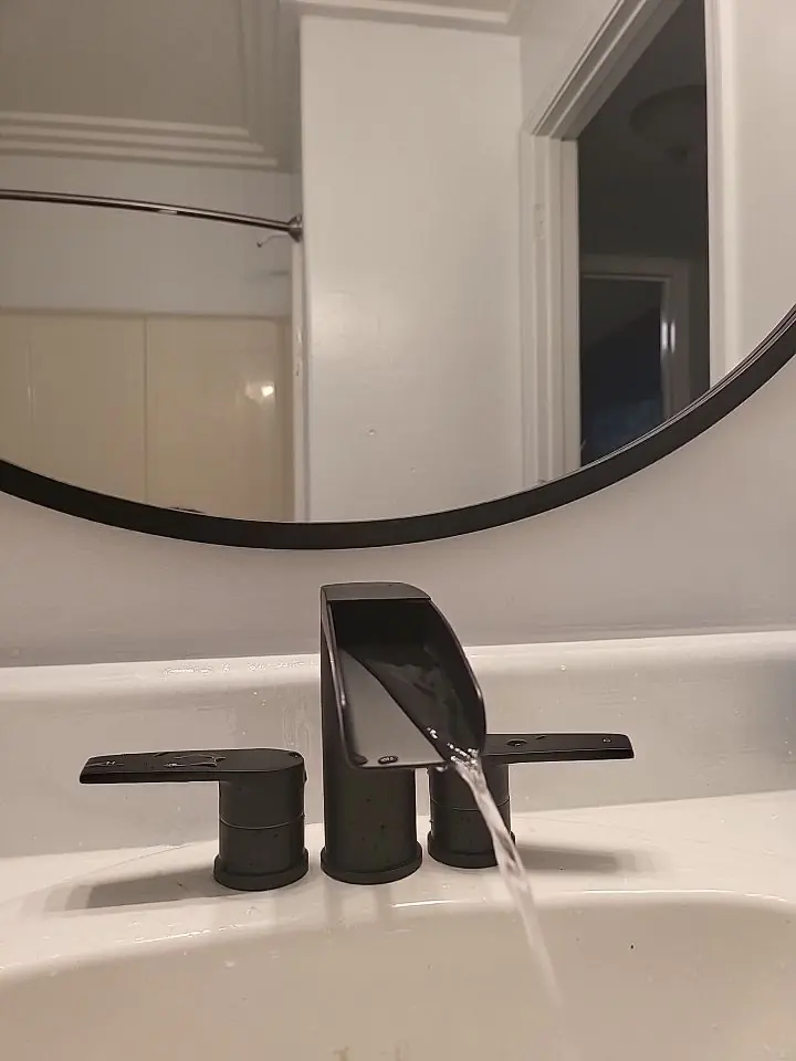 Modern black bathroom faucet installed by Honey Bee Plumbing
