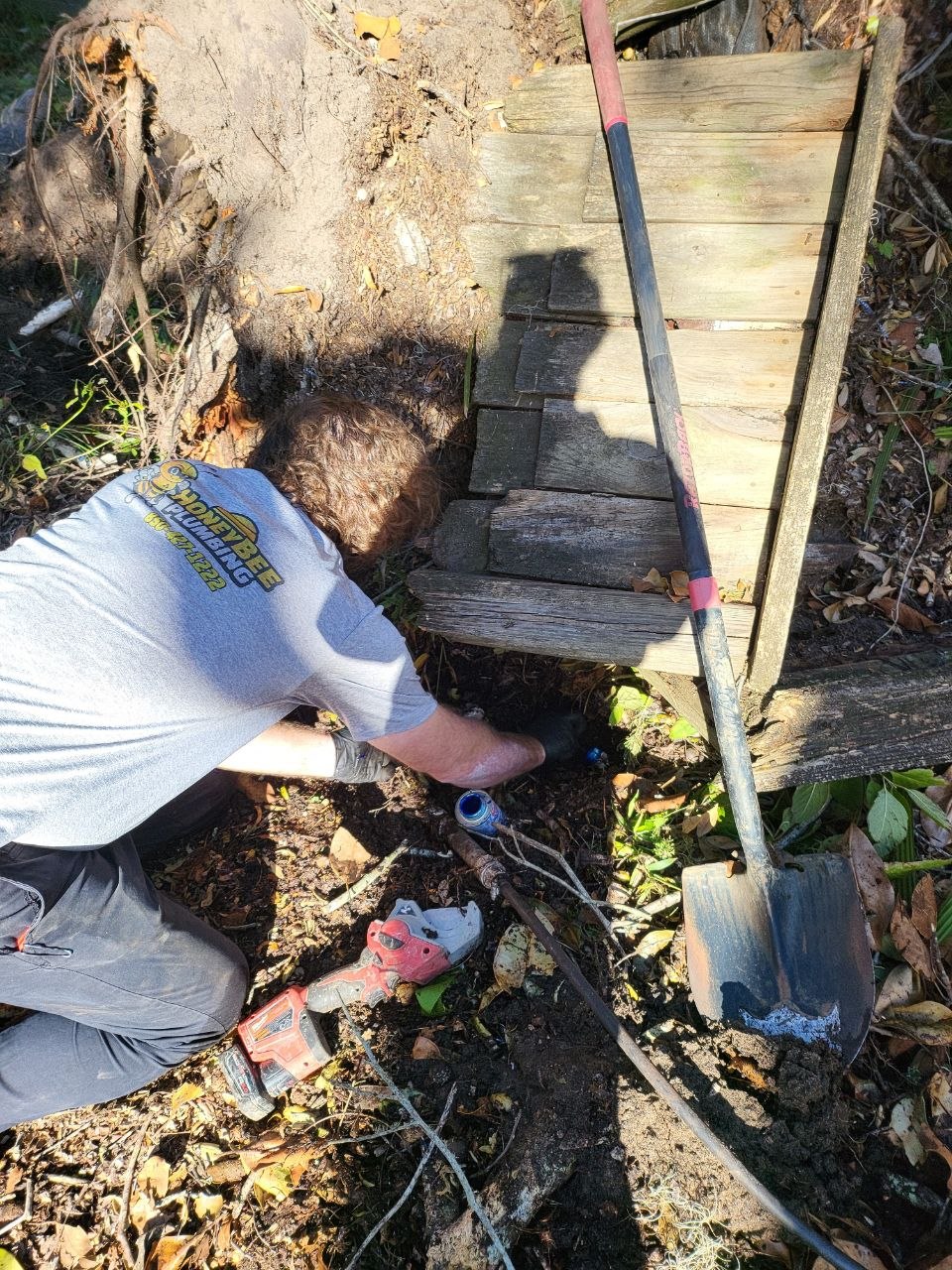 Honey Bee Plumbing helping reach outdoor plumbing after fallen-tree damage