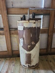 Old rusted water heater showing signs of wear and leaks did not prevent water heater leaks.