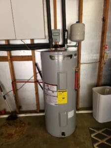 Well-maintained water heater in a clean utility room to prevent water heater leaks.